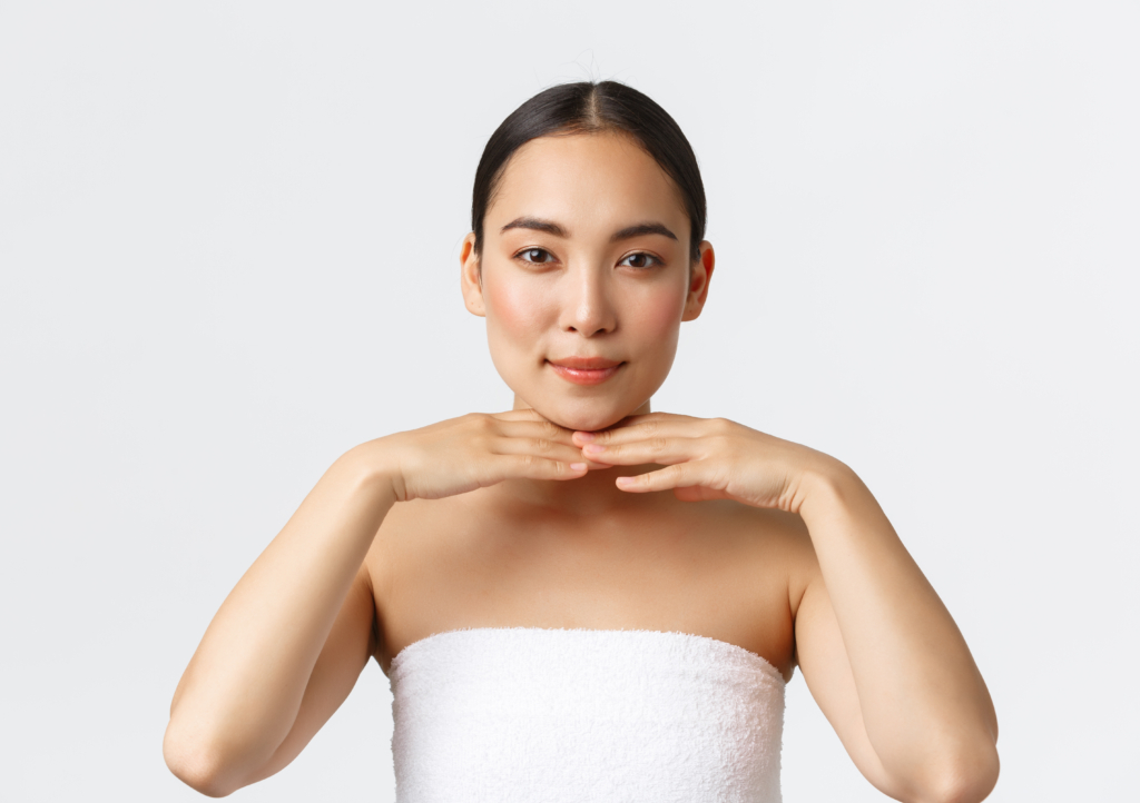 Asiatische Frau stützt ihr Kinn mit den Armen und blickt geradeaus