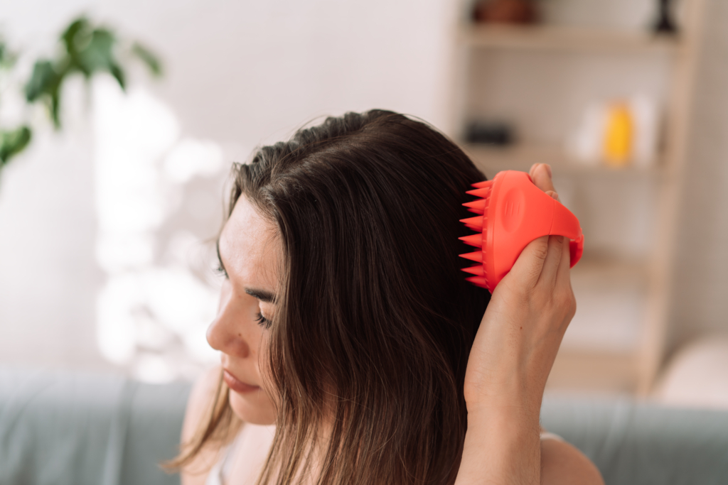 Frau bürsten sich mit einer Scalp Brush die Haare